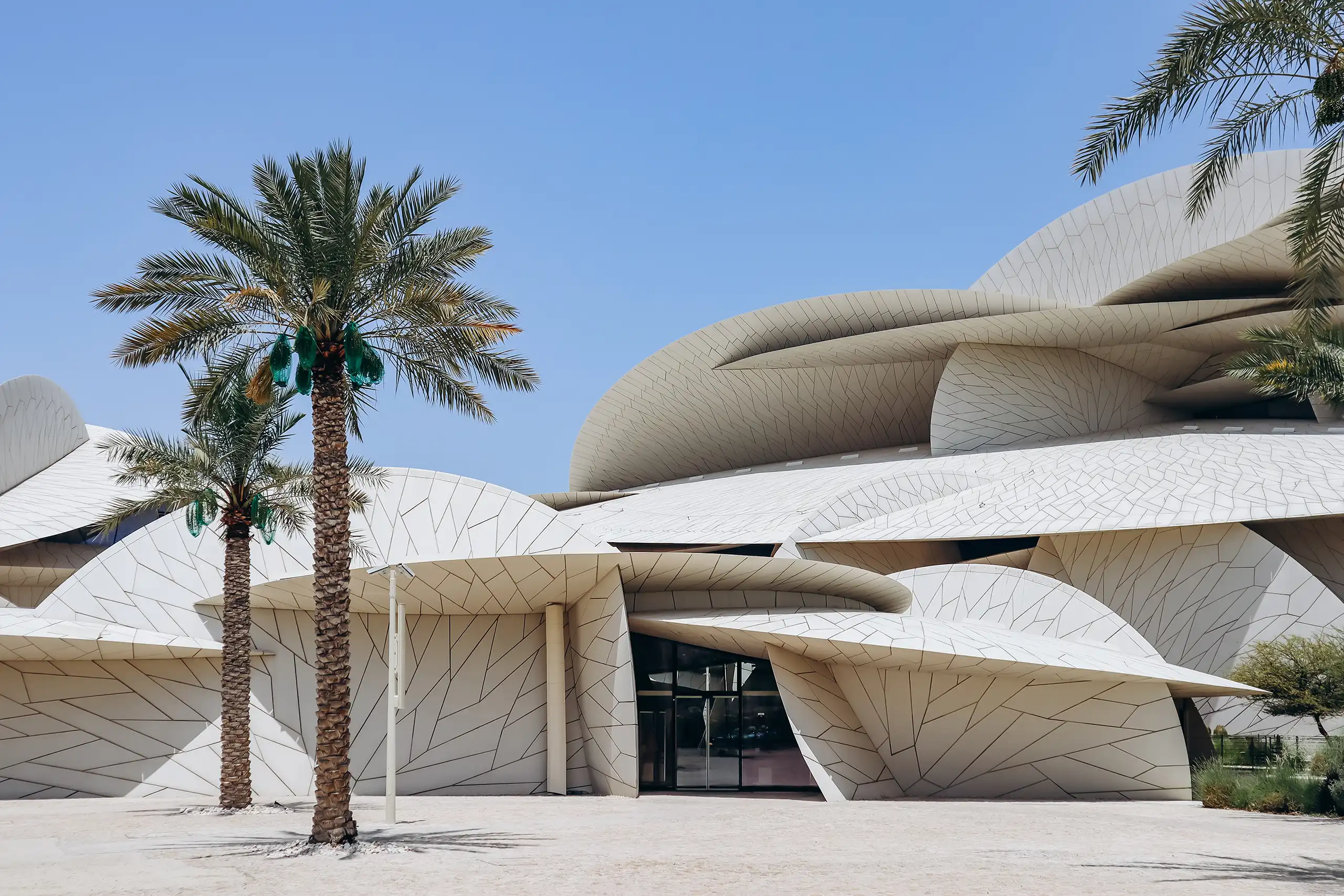 National Museum of Qatar in Doha mit Palmen vor der Wüstenrosen-Architektur