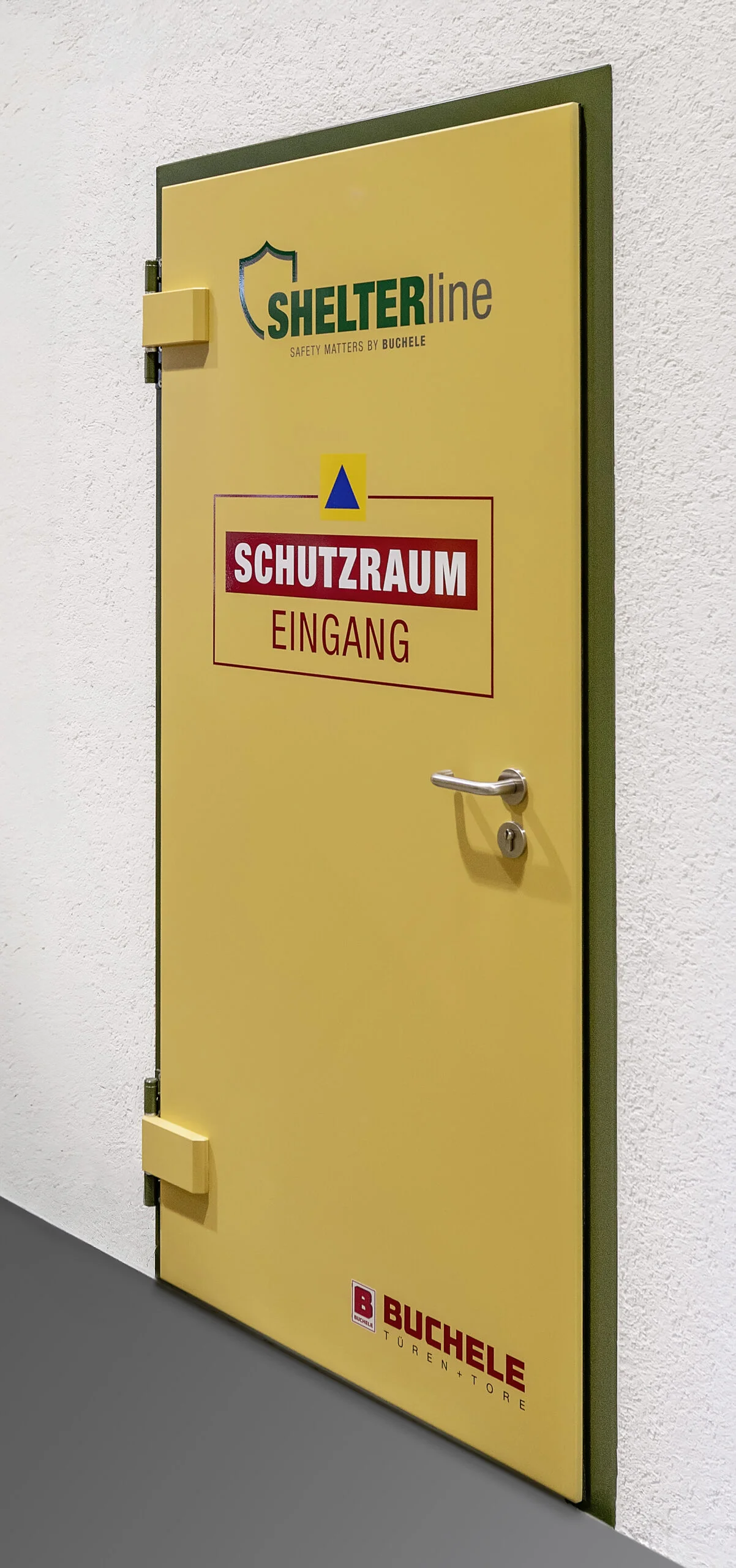 Yellow SHELTER LINE shelter door by BUCHELE with shelter entrance sign